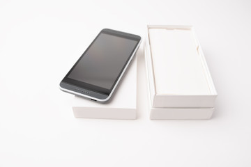 Opened mockup paper or cardboard box package with mobile phone isolated on white background. 