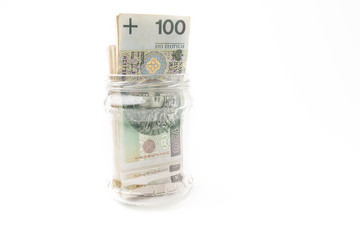 File of paper banknotes in a jar showing our saving or savings for the future and retirement. Financial freedom by postponing savings, passive income. Collected money. White Isolated Background.