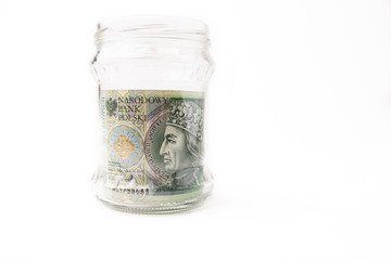 File of paper banknotes in a jar showing our saving or savings for the future and retirement. Financial freedom by postponing savings, passive income. Collected money. White Isolated Background.