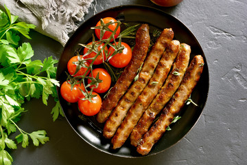 Roasted sausages and cherry tomatoes