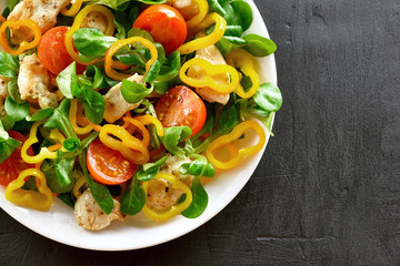 Vegetable salad with pieces of chicken meat