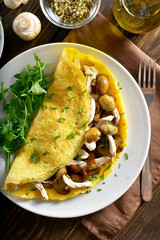 Omelette filling with mushrooms, chicken meat, greens
