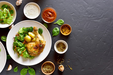 Grilled chicken leg with potato and green salad