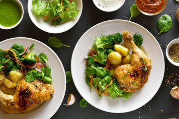Grilled chicken leg with potato and green salad