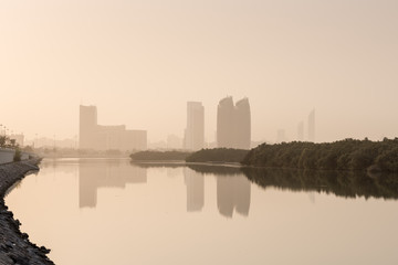 Al Bahr Towers and Mangroves reflection in the sea