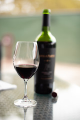 A glass of dark red wine waiting to be enjoyed.