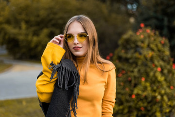 Street portrait of young beautiful woman wearing stylish vintage clothes. Model looking up. Female fashion concept. Emotions, people, beauty and lifestyle concept. Cute teenage girl.