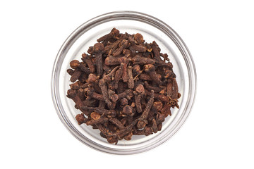 Dry Cloves Spice in a glass cup, top view, isolated on white background.