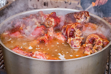 the pot with boiled smoked pigs