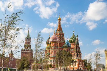 Fototapeta na wymiar View on Saint Basil Cathedral and Spasskaya tower of Kremlin from Zaryadye park. Famous russian landmarks at autumn.