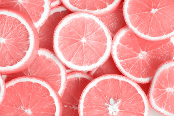 Pink citrus fruits - cuts, slices, halves. Closeup of pink fruits, oranges, grapefruits.