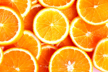 Top view of orange fruit slices, halves, cuts. Citrus fruits background.