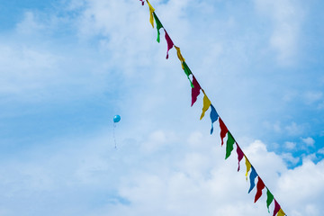 Holiday, balloons rushing up, colorful flags.