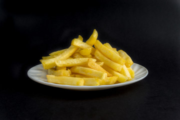 Potato fry or fries on dark background