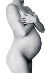 Naklejka premium Naked pregnant woman posing against white background, isolated