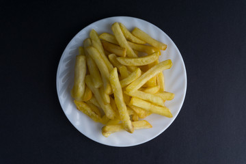 Potato fry or fries on dark background