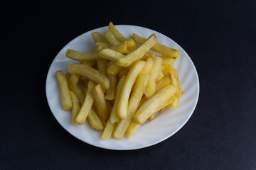 Potato fry or fries on dark background