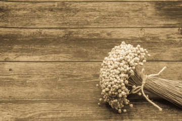 Bouquet of dried flowers on  wooden background.