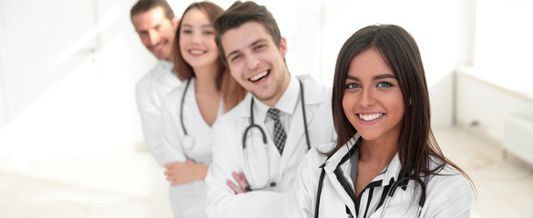 female doctor with group of happy successful colleagues