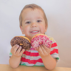 child chooses sweets. boy with a donut.