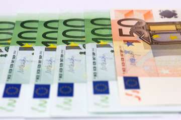 Money is a symbol of material wealth. European Union currency protection and recognition signs in close up view.