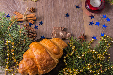 Fragrant croissant on a wooden background with Christmas-tree decoration - 226106996