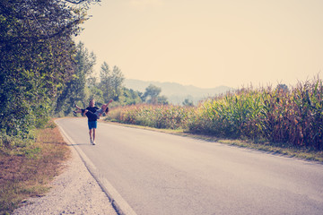 Obraz premium happy couple jogging along a country road