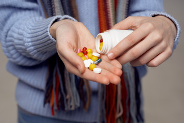 hands of woman with pills