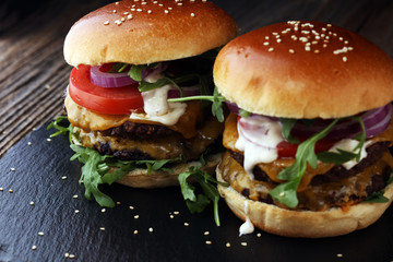 Tasty fresh meat burgers with salad and cheese. Homemade angus burger.