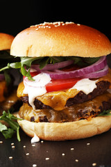 Tasty fresh meat burgers with salad and cheese. Homemade angus burger.
