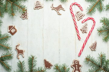 Fototapeta na wymiar Christmas background on white wooden boards with biscuits and gifts,Christmas cookies