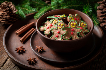Tasty cookies in the shape of man on rustic tray