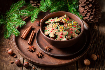 Sweet cookies in the shape of man on rustic tray