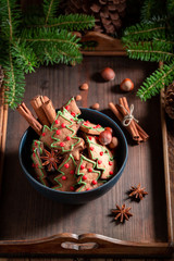 Delicious cookies in the shape of Christmas tree with pinecone