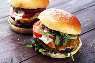 Tasty fresh meat burgers with salad and cheese. Homemade angus burger.