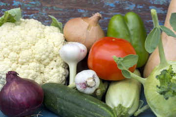 Vegetables piled on top of each other. Cauliflower, garlic, eggplant, zucchini, pepper,kohlrabi, cucumber - set of vegetarian ingredients