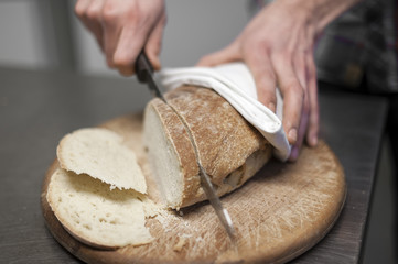 Mann schneidet Brot