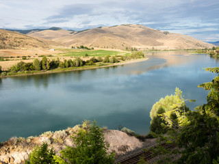 Railroad tracks running along scenic and wild Flathead river near Perma, Montana, USA