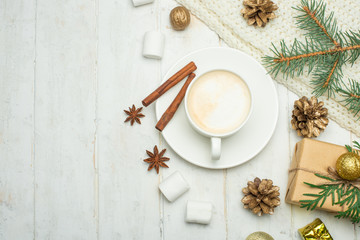 Christmas composition in Scandinavian style. Christmas gifts, coffee with marshmallows, pine cones, spruce branches on a wooden white background. Flat lay. view from above, place to copy. Banner