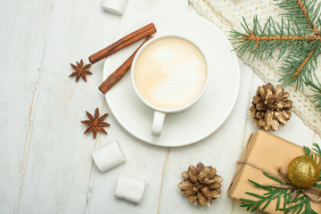 Christmas composition in Scandinavian style. Christmas gifts, coffee with marshmallows, pine cones, spruce branches on a wooden white background. Flat lay