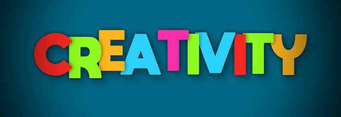 Creativity - overlapping multicolor letters written on blue background