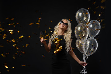 Brightfull expressions of happy emotions of  amazing blonde girl celebrating party on black...