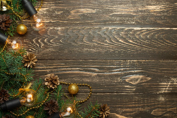 Christmas rustic background - old wooden board with backlight and branches of a Christmas tree and...