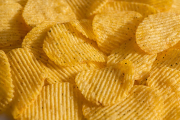 Handful of yellow potato chips