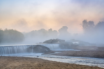 Mornig fog over a river diversion dam