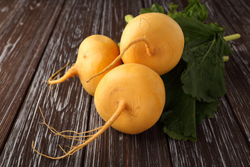 Yellow turnip on wooden background.