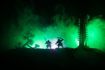 Samurai fighting concept. Silhouette of samurais in duel near tree and old temple. Picture with two...
