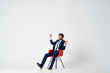 talks business man sitting on a chair on an isolated background