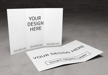 2 Trifold Brochures on Concrete Surface Mockup