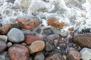 Colorful stones above the sea coast. Sea shore in central europe.